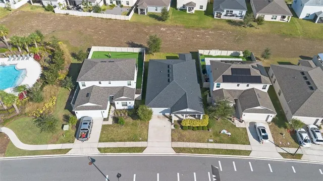 an aerial view of residential houses with outdoor space