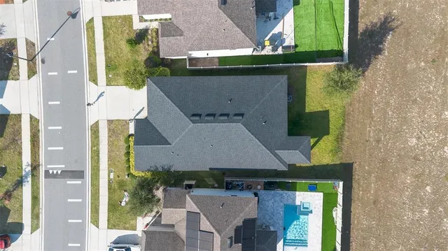 an aerial view of a house with a swimming pool