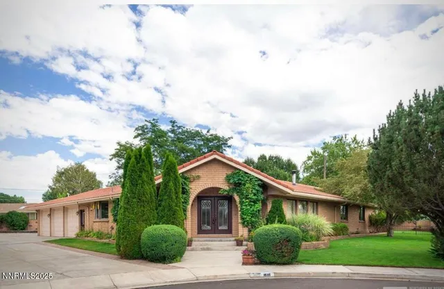 a front view of a house with garden