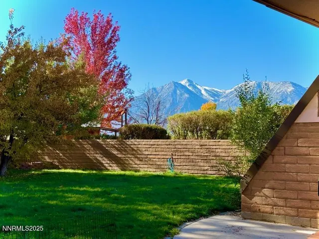 a living room with furniture a dining table and large windows