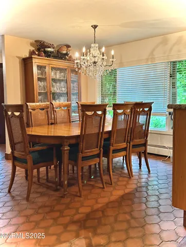 a view of a kitchen with wooden floor and a refrigerator