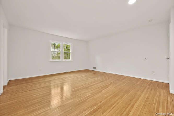93 Seton Drive New Rochelle, NY 10804 - Photo 16 of 31 a view of a room with wooden floor and white walls