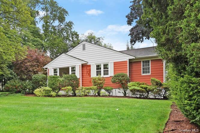 93 Seton Drive New Rochelle, NY 10804 - Photo 23 of 31 a front view of a house with a garden and plants