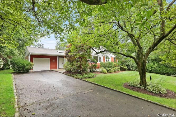 93 Seton Drive New Rochelle, NY 10804 - Photo 24 of 31 a front view of a house with a garden and trees