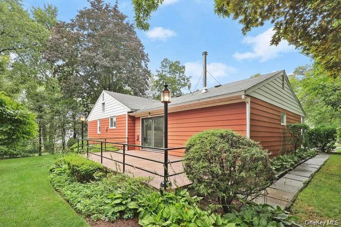 93 Seton Drive New Rochelle, NY 10804 - Photo 27 of 31 a view of a small house in front of a yard with plants and large trees