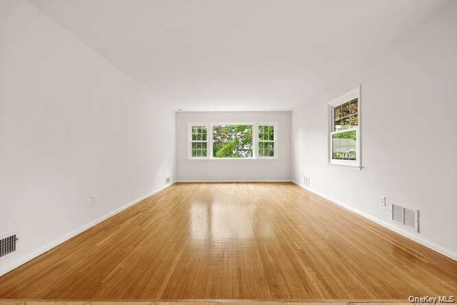 93 Seton Drive New Rochelle, NY 10804 - Photo 5 of 31 an empty room with wooden floor and windows