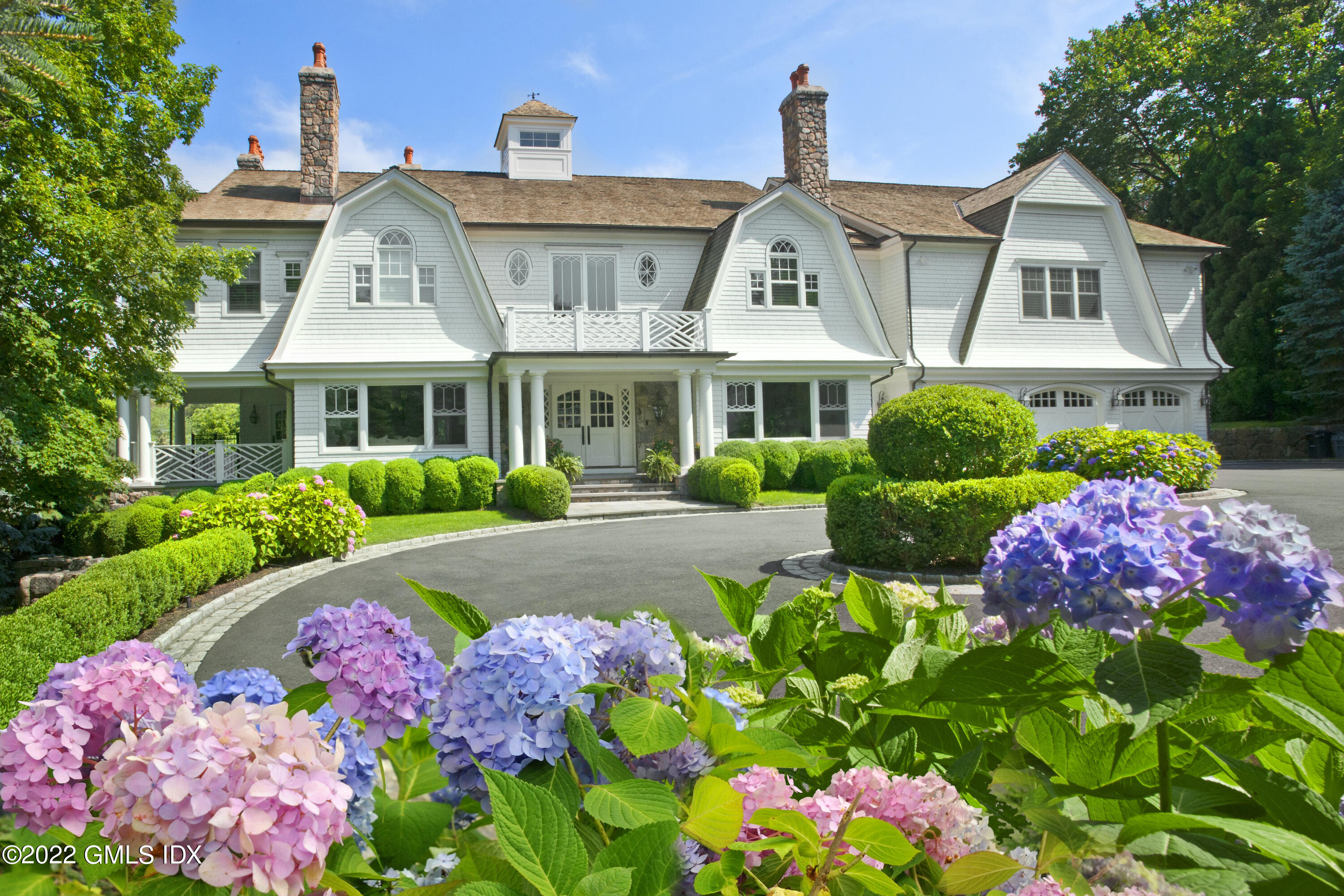 16 Dingletown Road Greenwich, CT 06830 - Photo 1 of 35 a front view of a house with a yard and fountain