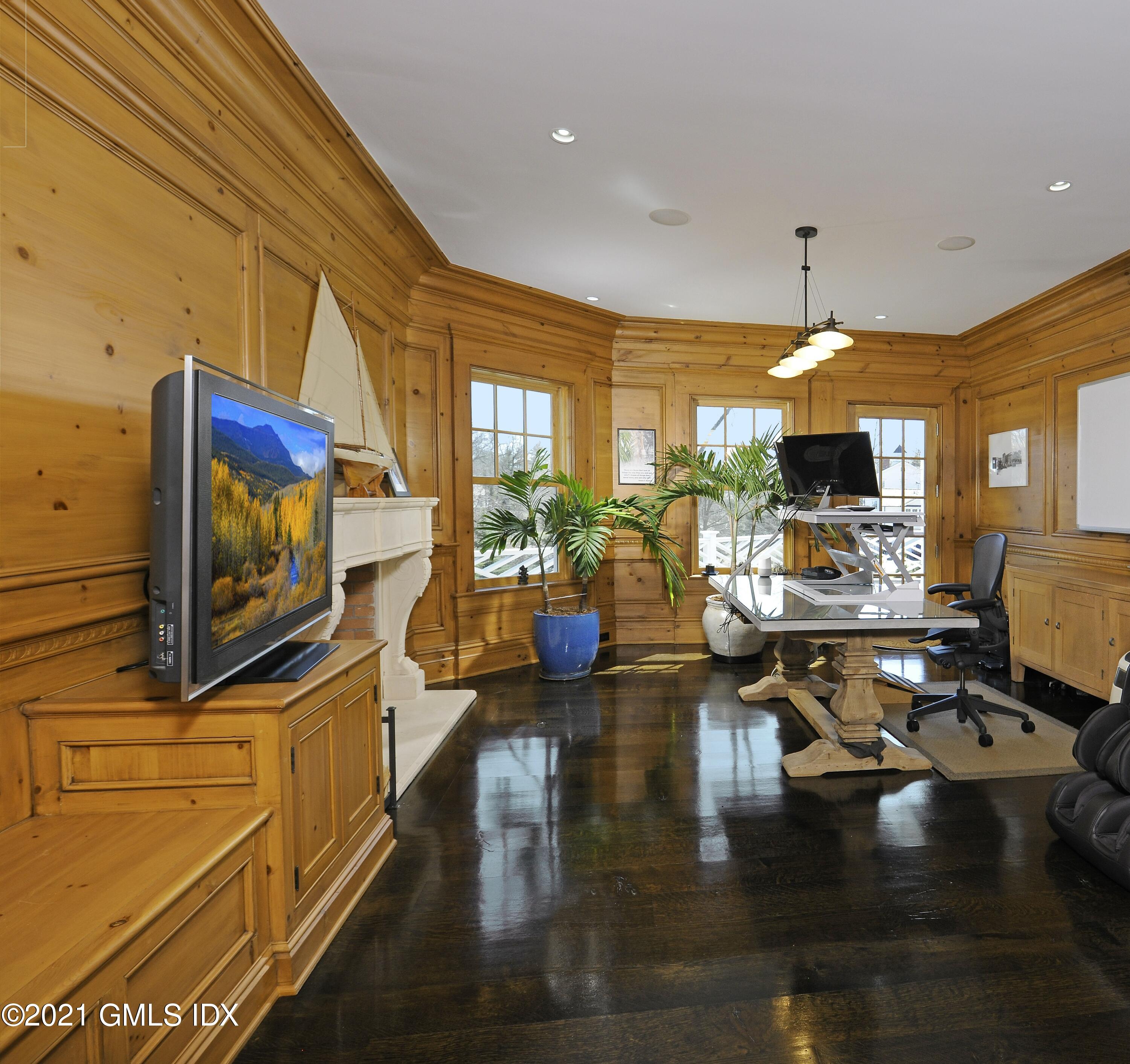 16 Dingletown Road Greenwich, CT 06830 - Photo 11 of 35 a living room with fireplace furniture and a flat screen tv