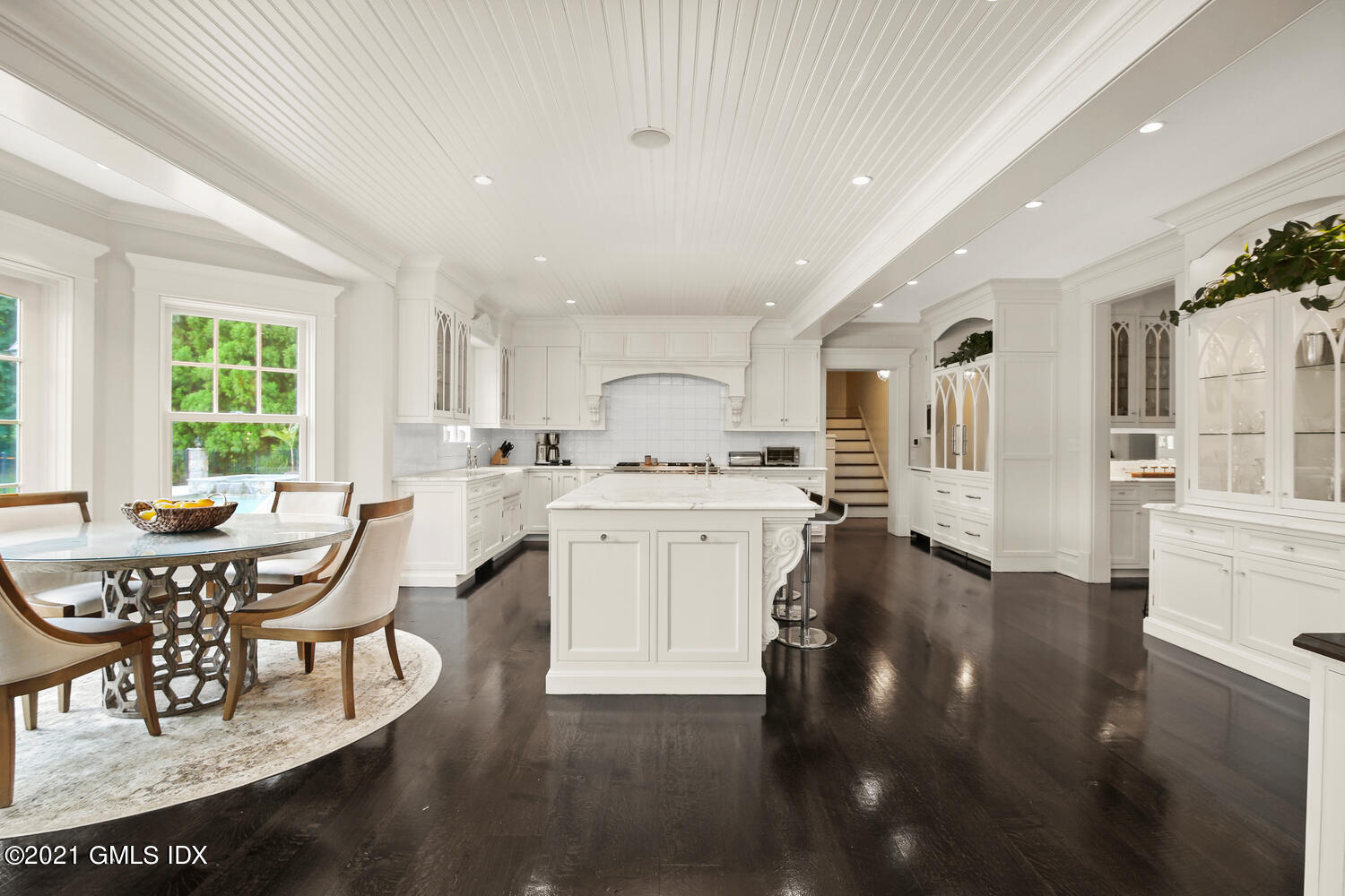 16 Dingletown Road Greenwich, CT 06830 - Photo 10 of 35 a kitchen with kitchen island granite countertop a stove a sink a dining table and chairs