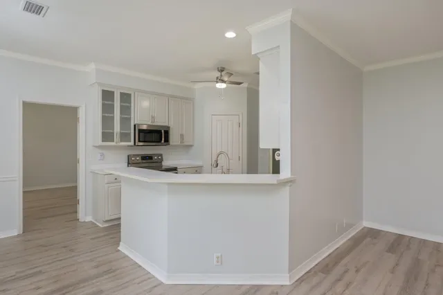 a kitchen with stainless steel appliances a sink and microwave