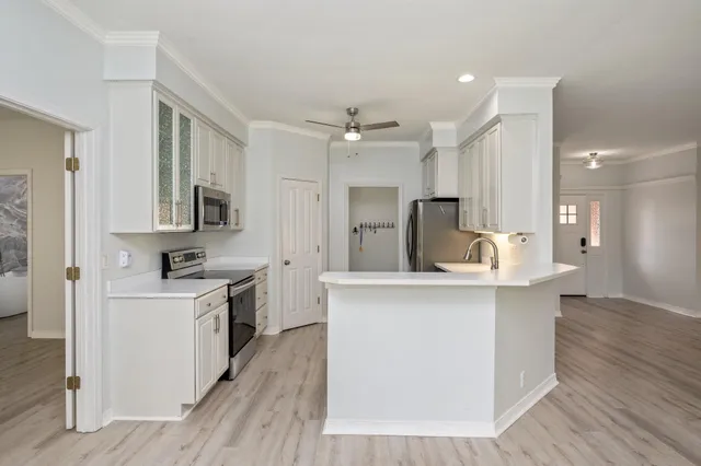 a kitchen with stainless steel appliances a sink stove and refrigerator