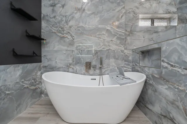 a white tub sitting in a bathroom