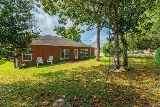 a backyard of a house with table and chairs