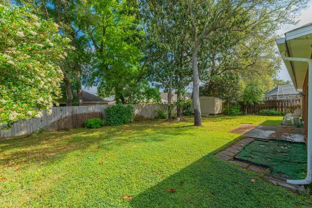 a view of a backyard with swimming pool