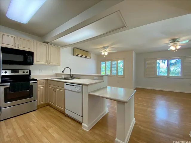 a kitchen with granite countertop a stove and a sink