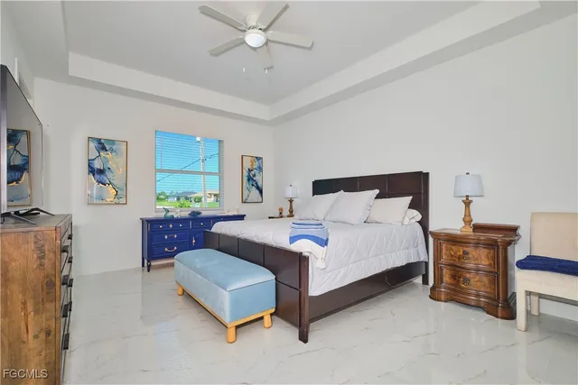 a spacious bedroom with a bed window and couch