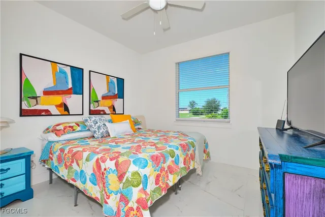 a bedroom with a bed and painting on the wall