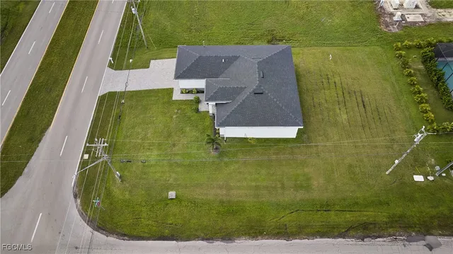 an aerial view of a residential houses with outdoor space