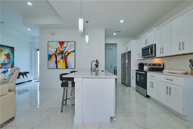 a large kitchen with stainless steel appliances lots of counter top space