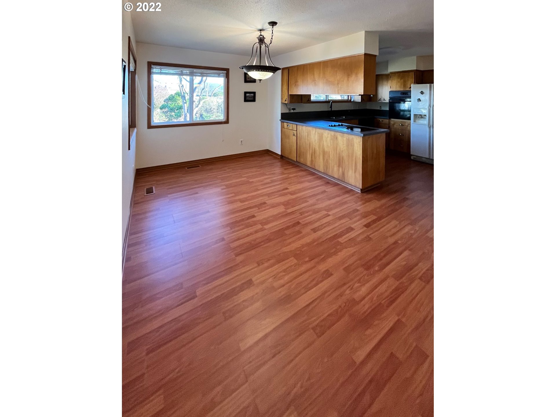 1675 Makinster Road Tillamook, OR 97141 - Photo 7 of 29 a kitchen with granite countertop white cabinets and appliances