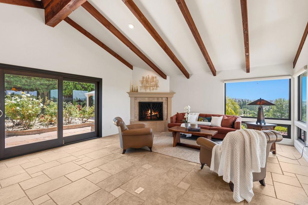 13319 Pacer Lane Poway, CA 92064 - Photo 5 of 75 a living room with furniture a fireplace and a floor to ceiling window