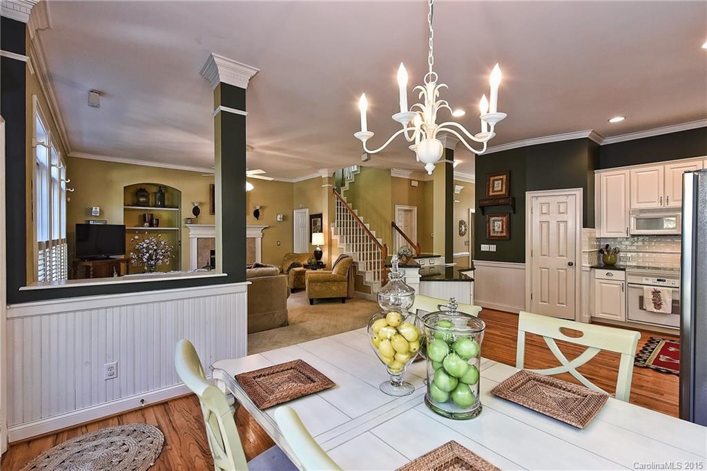 7109 Michael Scott Crossing Fort Mill, SC 29708 - Photo 14 of 24 a view of a dining room with furniture a chandelier and wooden floor