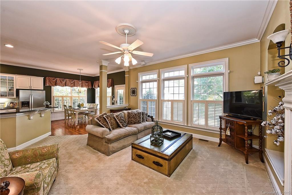 7109 Michael Scott Crossing Fort Mill, SC 29708 - Photo 8 of 24 a living room with furniture a flat screen tv and a large window