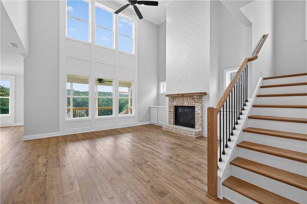 3787 Cheyenne Lane Jefferson, GA 30549 - Photo 11 of 82 a view of an empty room with wooden floor fireplace and a window