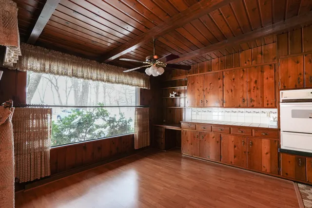 a spacious bedroom with a bed and a mirror