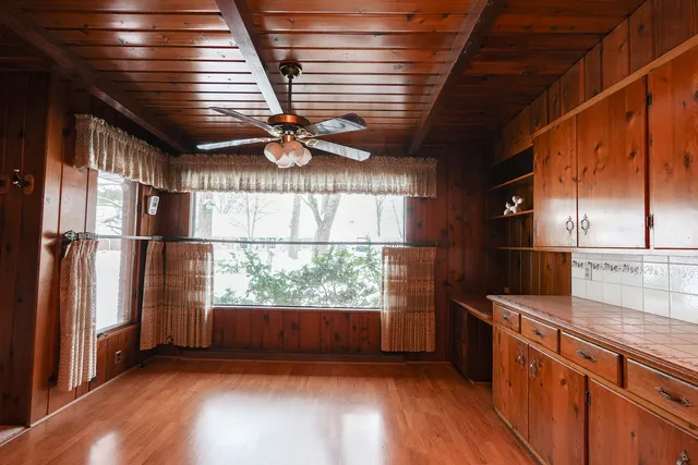 a kitchen with refrigerator and cabinets
