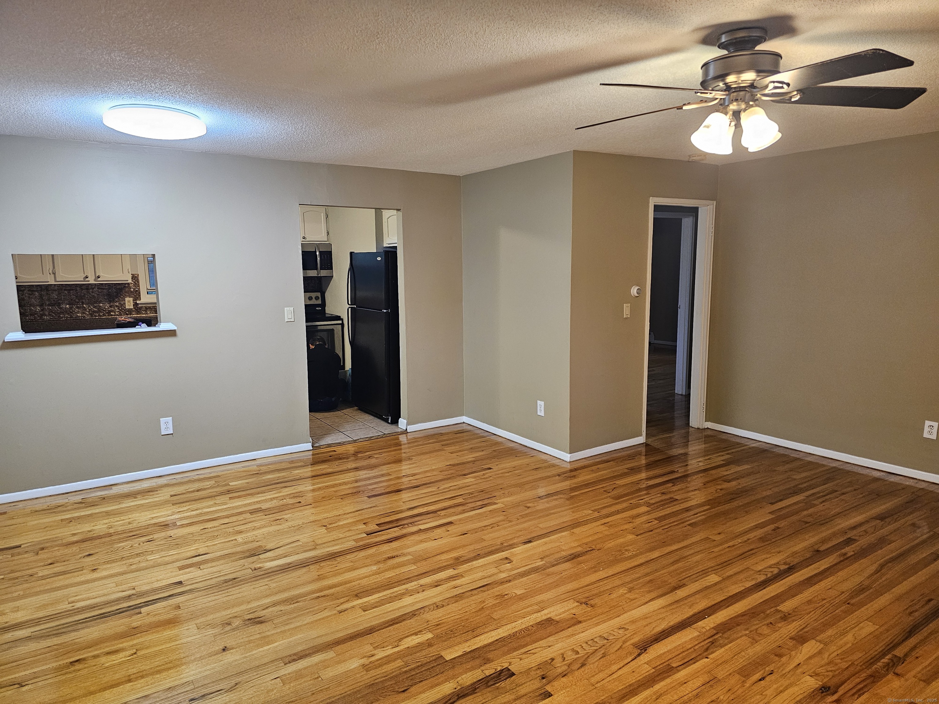 474 Oak Avenue, Unit 74 Cheshire, CT 06410 - Photo 3 of 10 a view of an empty room with window and wooden floor