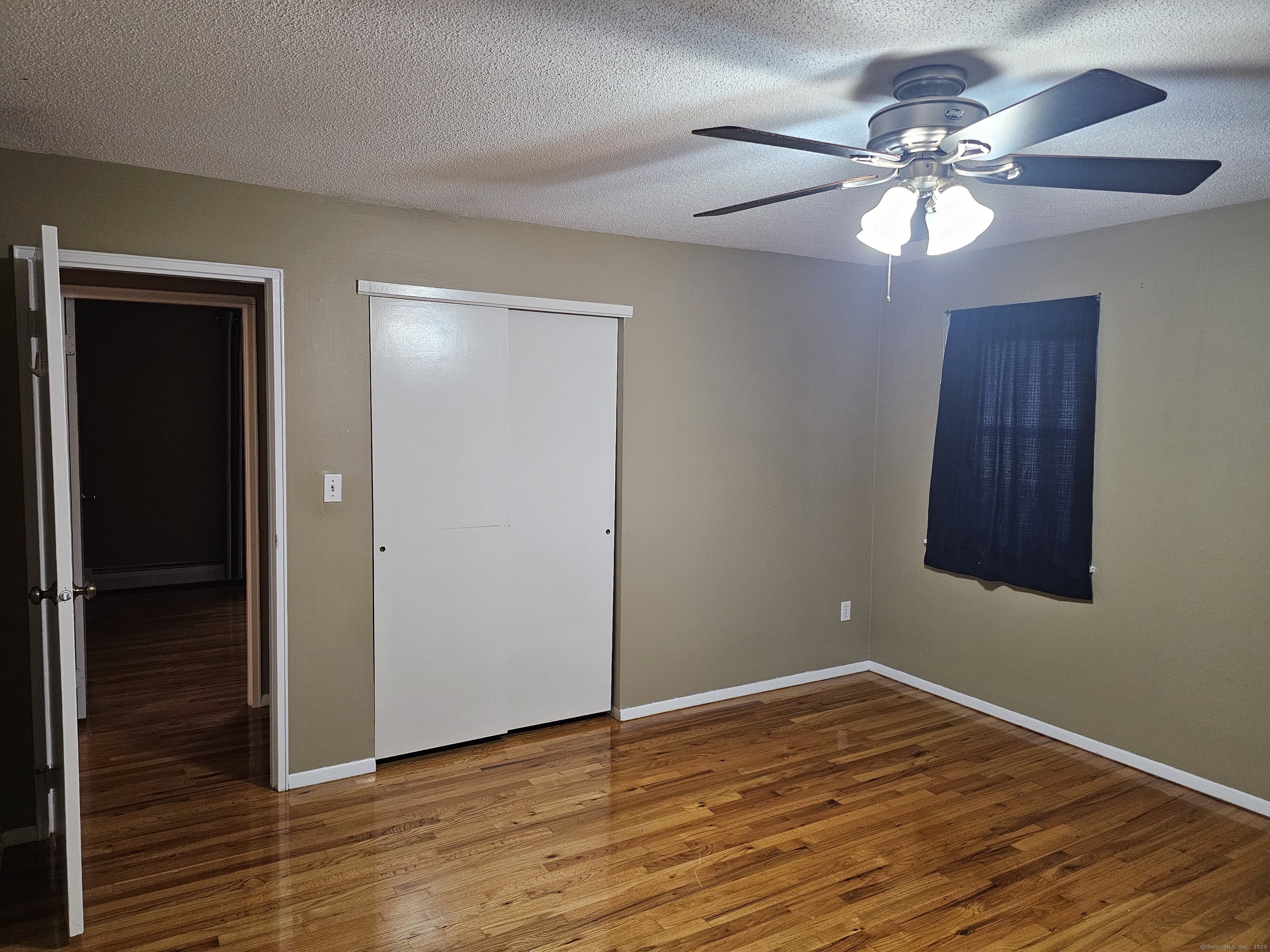 474 Oak Avenue, Unit 74 Cheshire, CT 06410 - Photo 5 of 10 a view of empty room with wooden floor