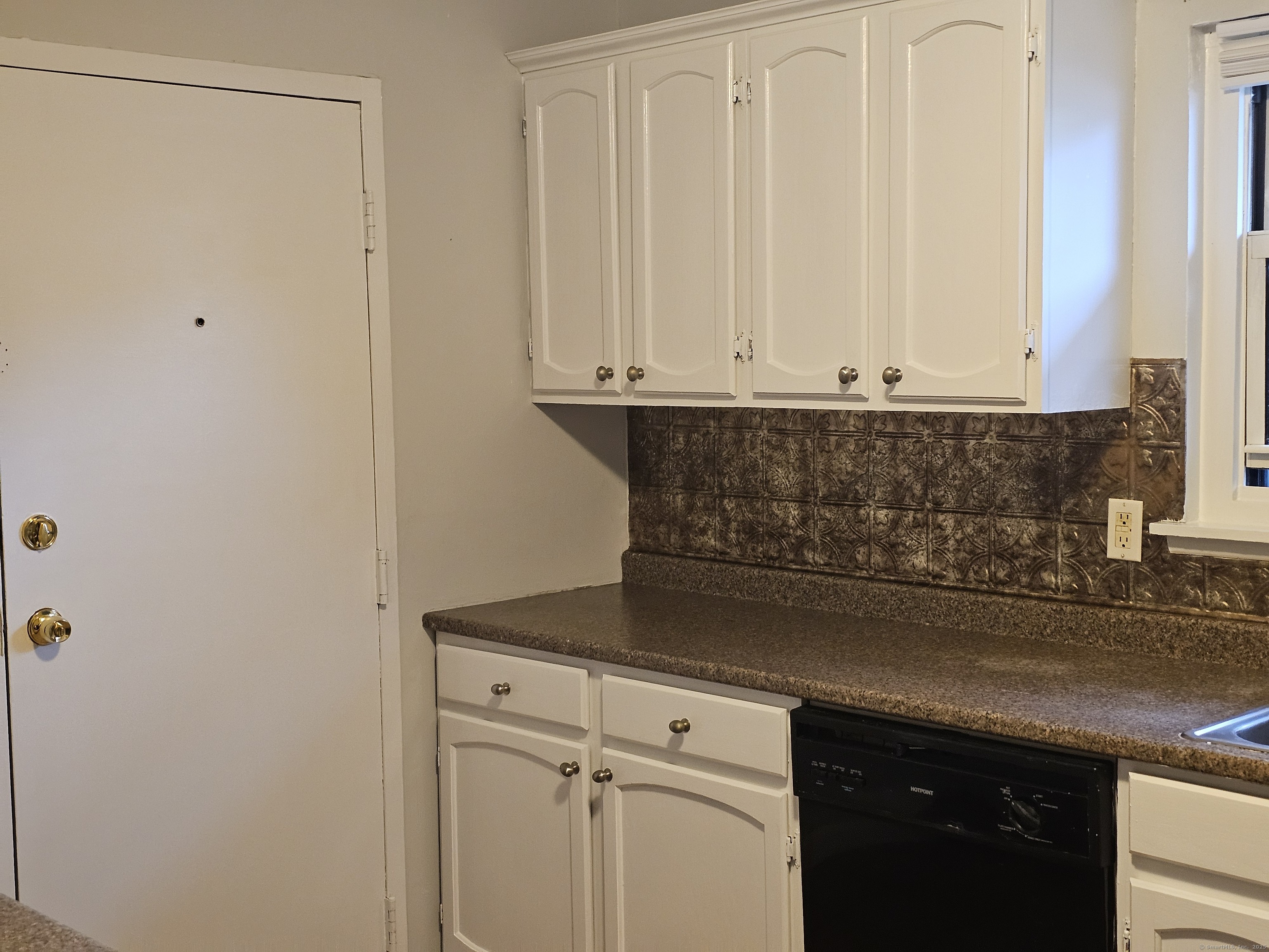 474 Oak Avenue, Unit 74 Cheshire, CT 06410 - Photo 9 of 10 a view of kitchen with granite countertop white cabinets and a granite counter tops