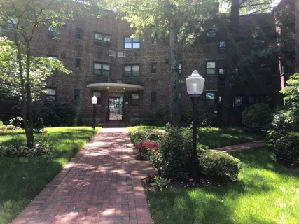 a front view of a house with a yard and a garden