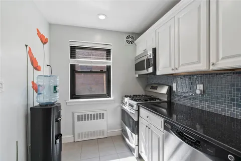 a kitchen with stainless steel appliances granite countertop a stove and a refrigerator