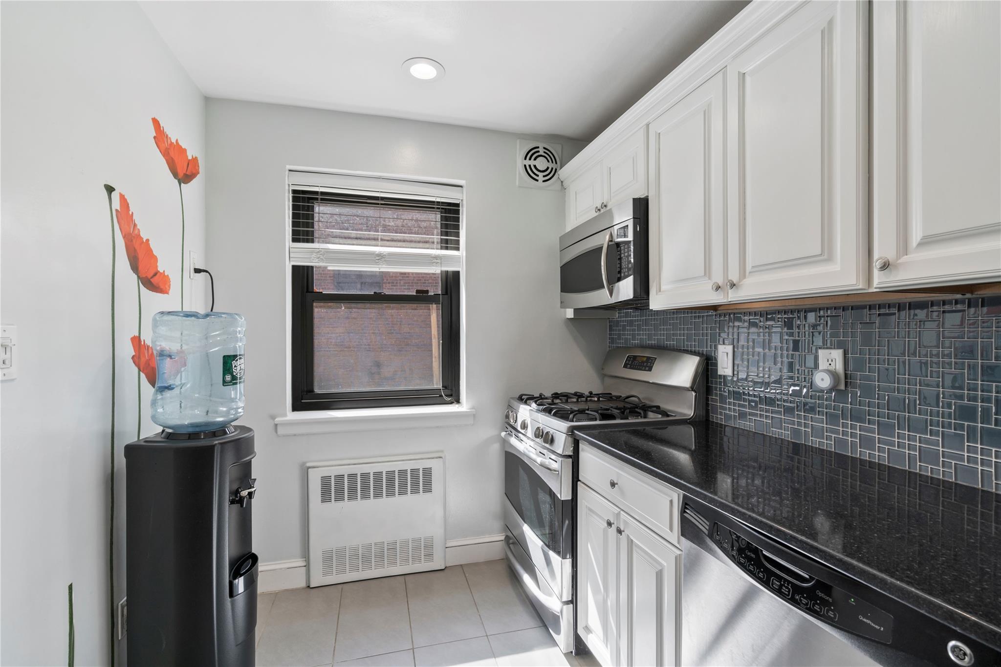 50 Brompton Road, Unit 1T Great Neck, NY 11021 - Photo 15 of 33 a kitchen with stainless steel appliances granite countertop a stove and a refrigerator