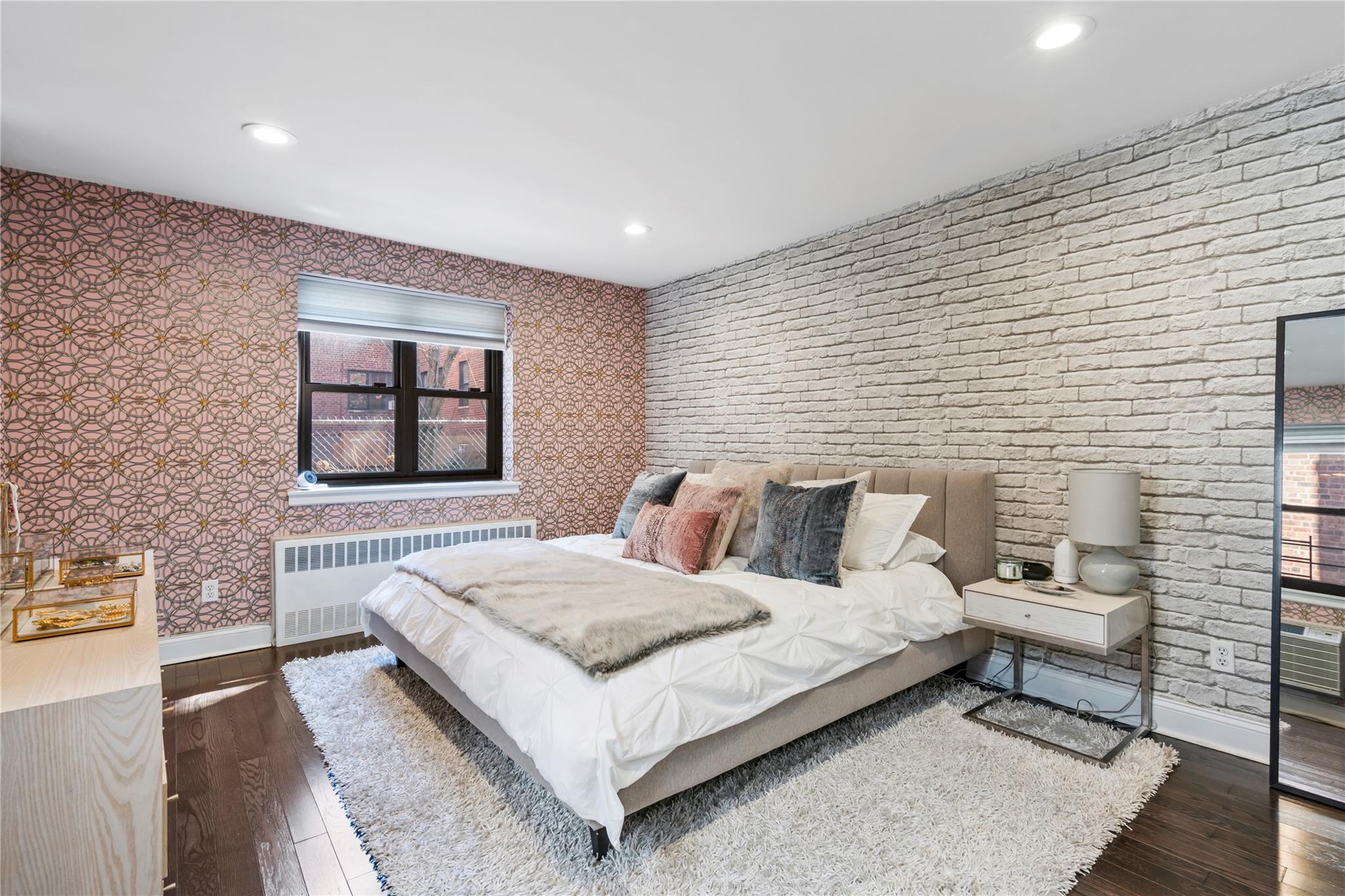 50 Brompton Road, Unit 1T Great Neck, NY 11021 - Photo 17 of 33 a bedroom with a bed and window