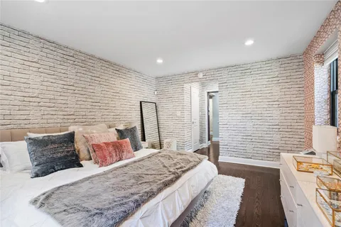 a bed sitting in a bedroom next to a window