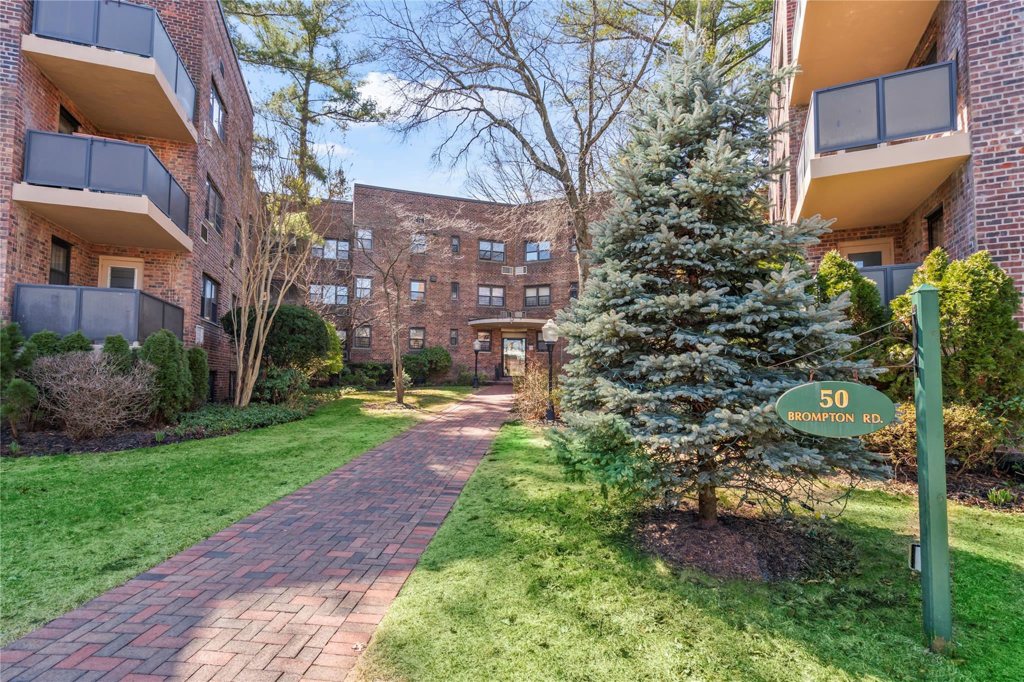 50 Brompton Road, Unit 1T Great Neck, NY 11021 - Photo 24 of 33 a view of a building with a garden