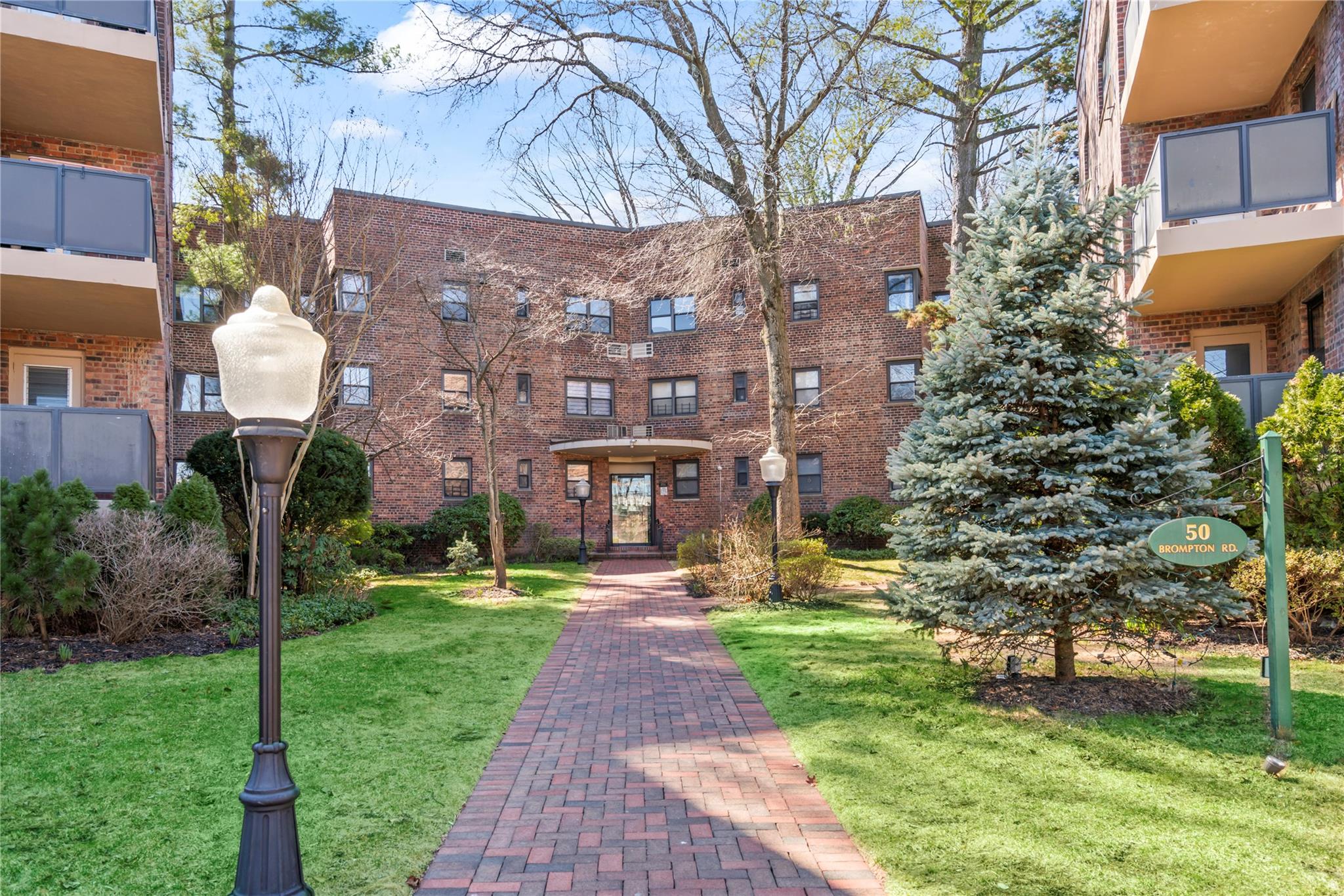 50 Brompton Road, Unit 1T Great Neck, NY 11021 - Photo 25 of 33 a view of a building with garden