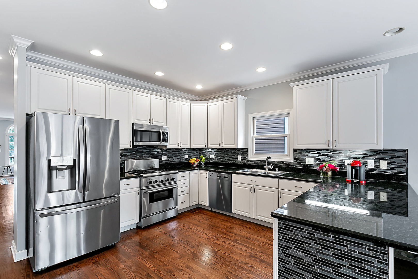 1910 West Barry Avenue Chicago, IL 60657 - Photo 12 of 33 a kitchen with kitchen island granite countertop a sink stainless steel appliances and cabinets