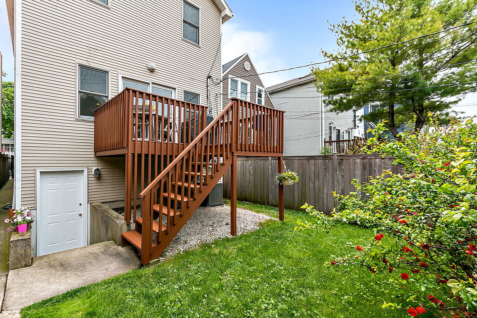 1910 West Barry Avenue Chicago, IL 60657 - Photo 16 of 33 a view of a house with a small yard and wooden fence