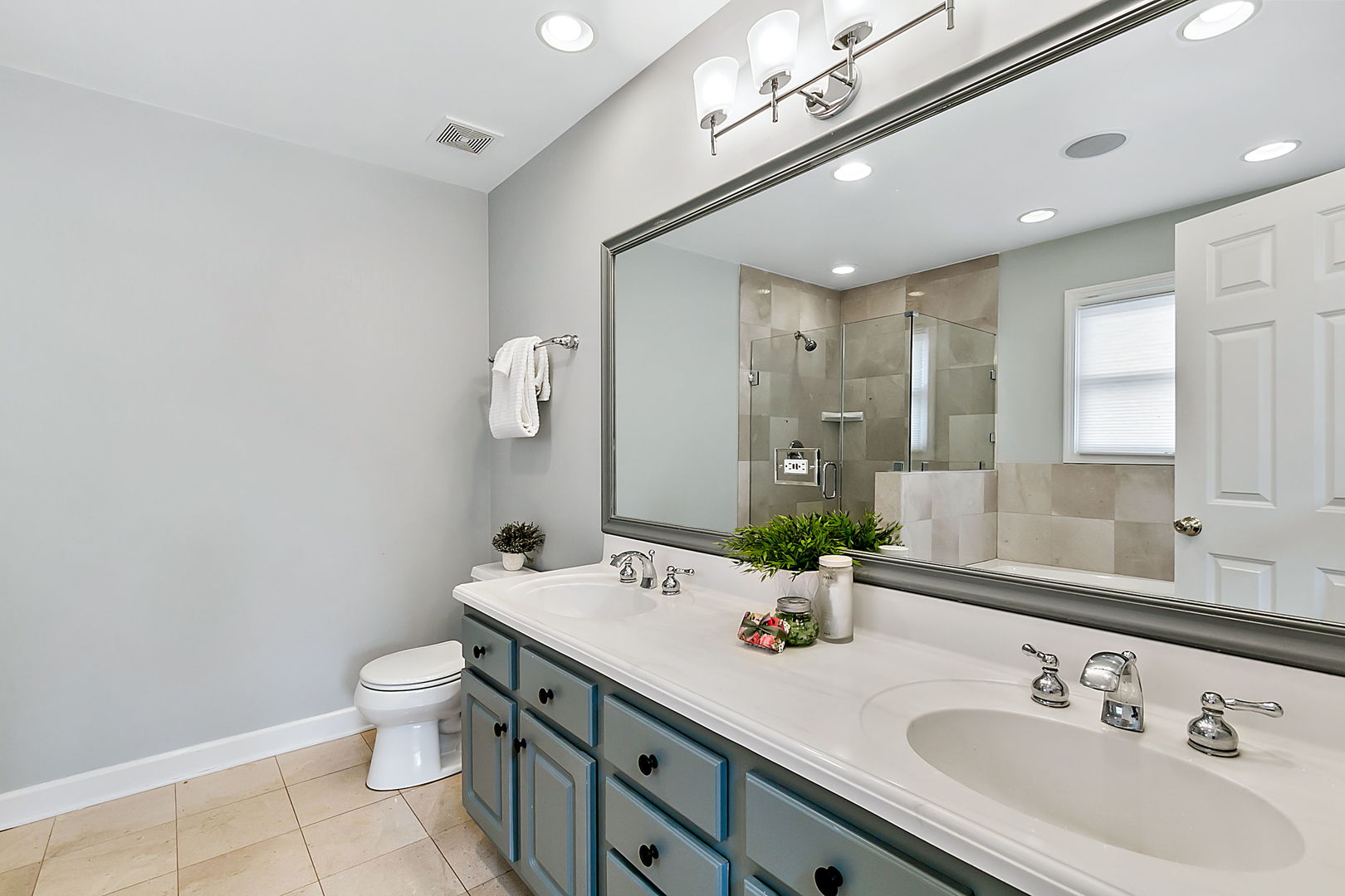 1910 West Barry Avenue Chicago, IL 60657 - Photo 22 of 33 a bathroom with a double vanity sink mirror and toilet