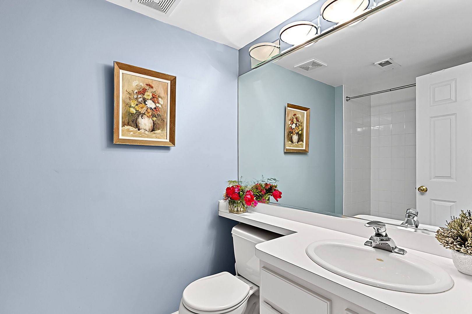 1910 West Barry Avenue Chicago, IL 60657 - Photo 31 of 33 a bathroom with a toilet sink and a mirror