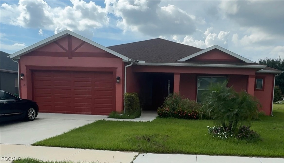 1473 Bush Street West Immokalee, FL 34142 - Photo 1 of 9 a front view of a house with a yard