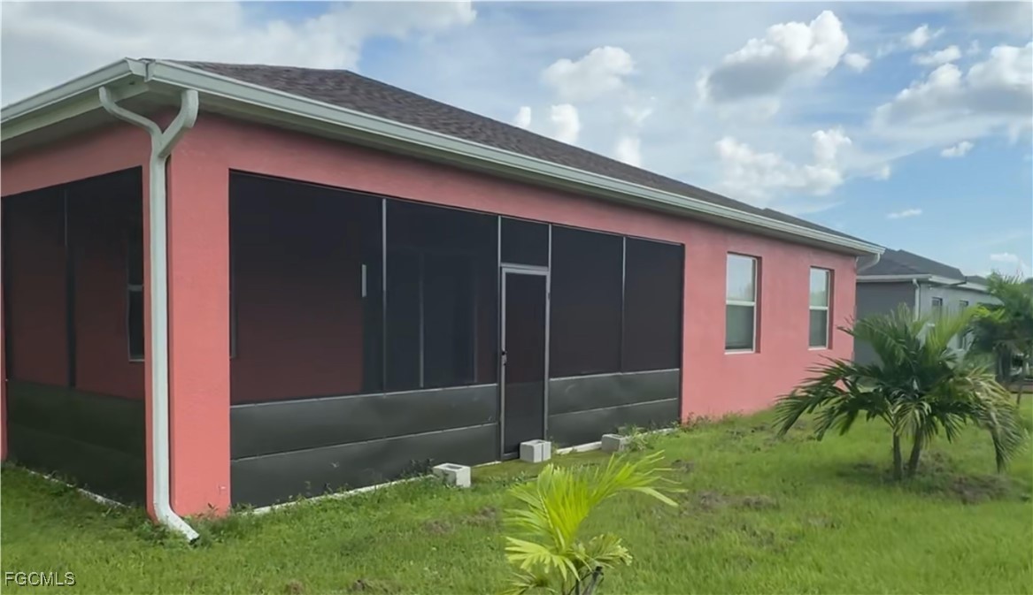 1473 Bush Street West Immokalee, FL 34142 - Photo 5 of 9 a backyard of a house with potted plants and a yard