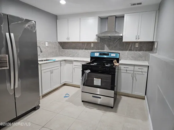 a kitchen with cabinets and appliances