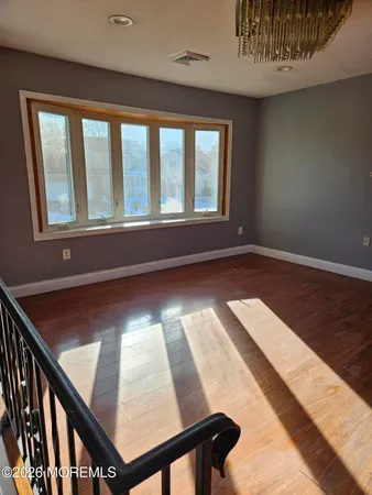 a view of wooden floor and dining room