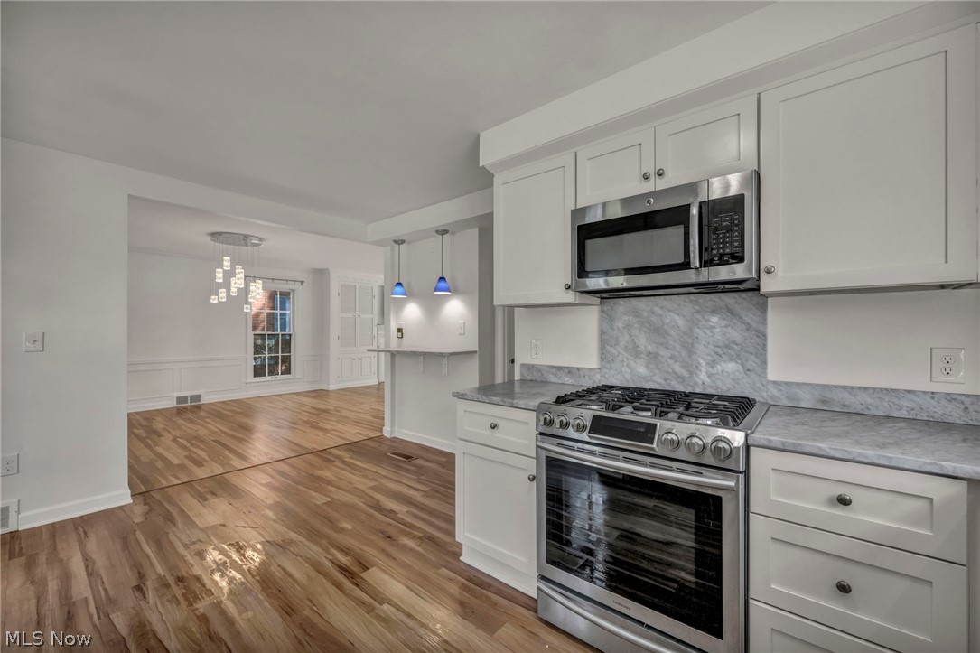 3543 Lytle Road Shaker Heights, OH 44122 - Photo 22 of 49 Contemporary kitchen featuring white cabinetry, stainless steel oven with gas range, and a built-in microwave