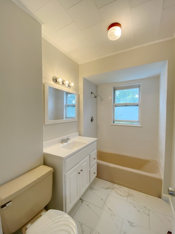 9 Cresthill Road, Unit 2 Somerville, MA 02145 - Photo 15 of 18 a bathroom with a toilet sink and mirror